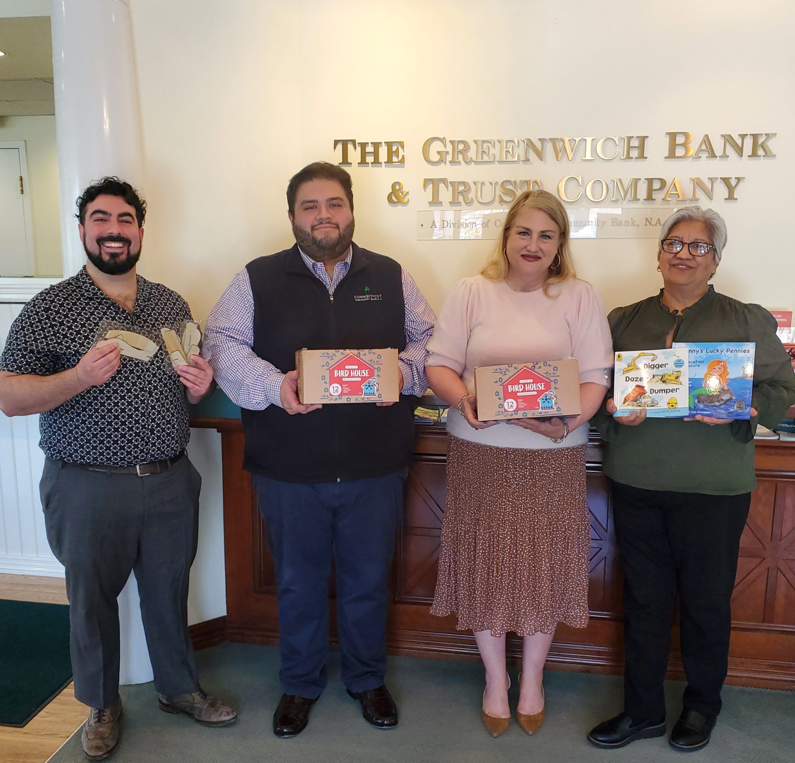 Bank donation to Family Centers of Greenwich of books, airplane kits and birdhouse kits for their Spring Family Literacy Program.